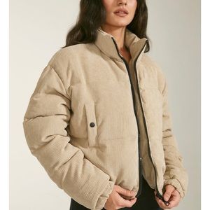Beige cropped funnel neck jacket.